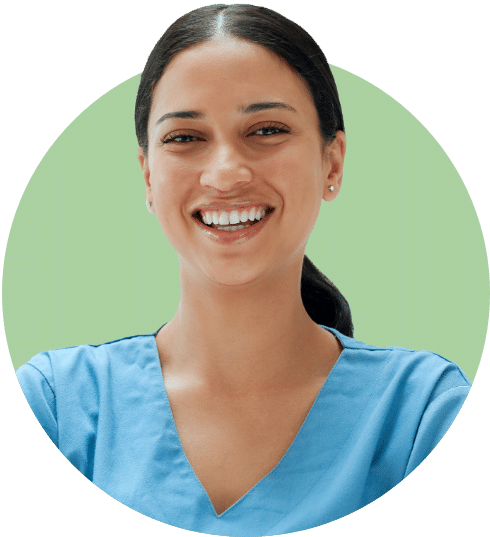 Smiling female caregiver in blue scrubs, representing the compassionate and professional team at Advanced Nursing & Home Care.