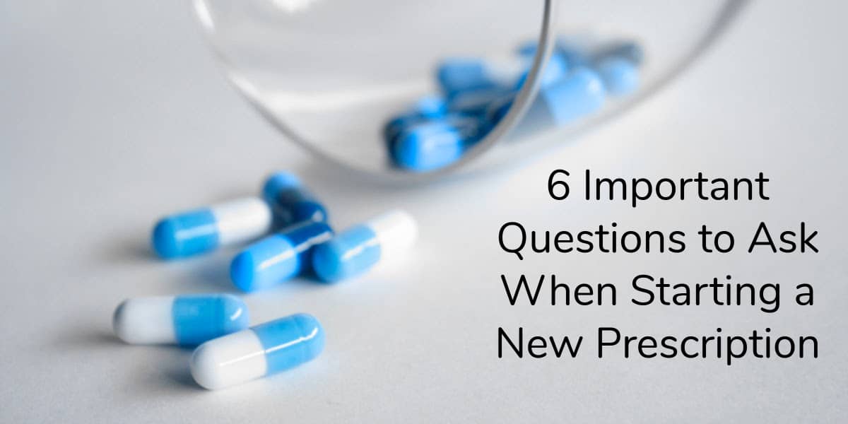 Blue and white pills dumped out of a clear glass