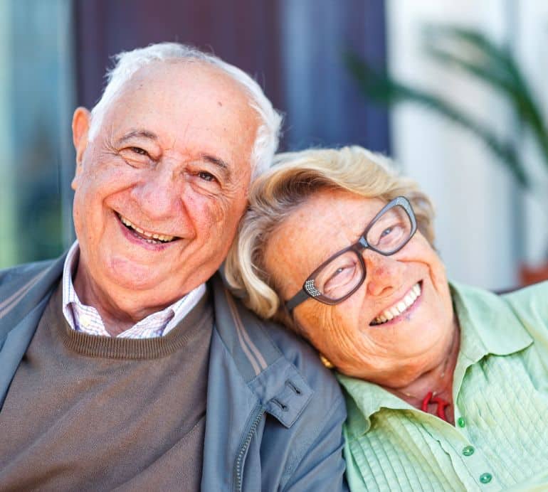 Smiling senior couple enjoying time together, representing the comfort, happiness, and support provided by Advanced Nursing & Home Care services.