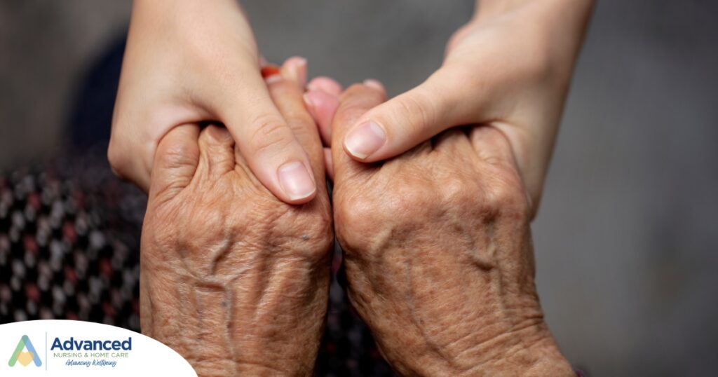 Younger hands hold older ones, representing the care and compassion of caregiving and how caregivers can help, even in ways like implementing stroke prevention strategies.