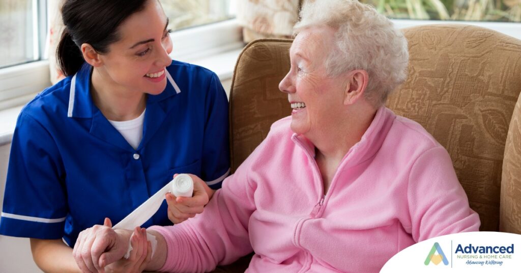 A caregiver demonstrates wound care by wrapping a senior client’s wound.
