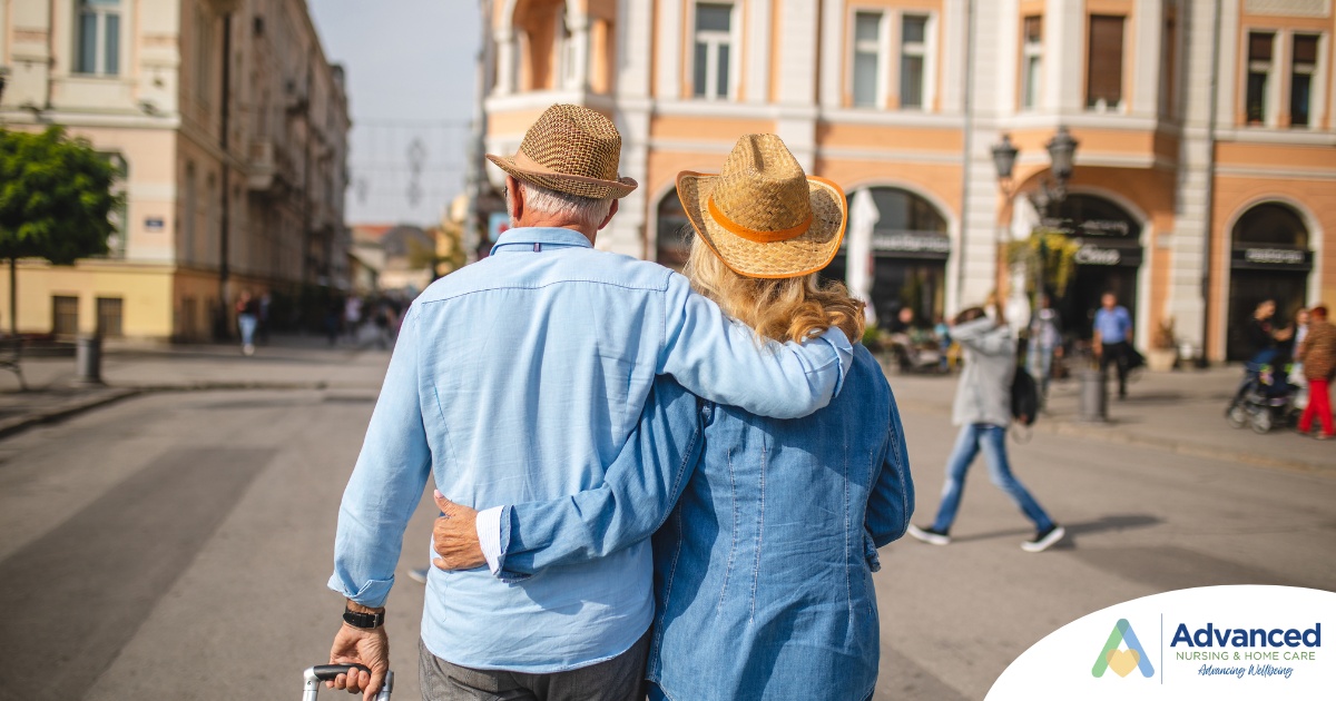 2 older adults hug while on vacation representing the successful outing that can still happen while caring for elderly loved ones.