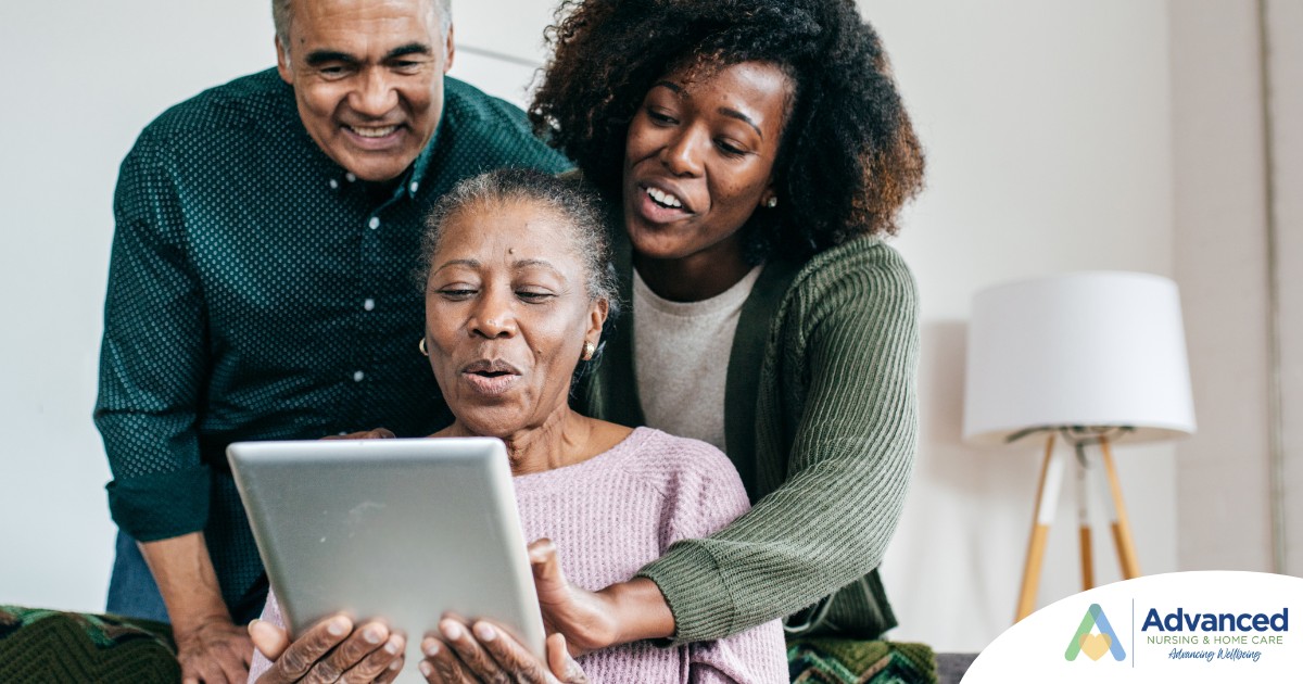 A daughter looks at a tablet with her older parents, representing technology and how ti can help with aging in place.