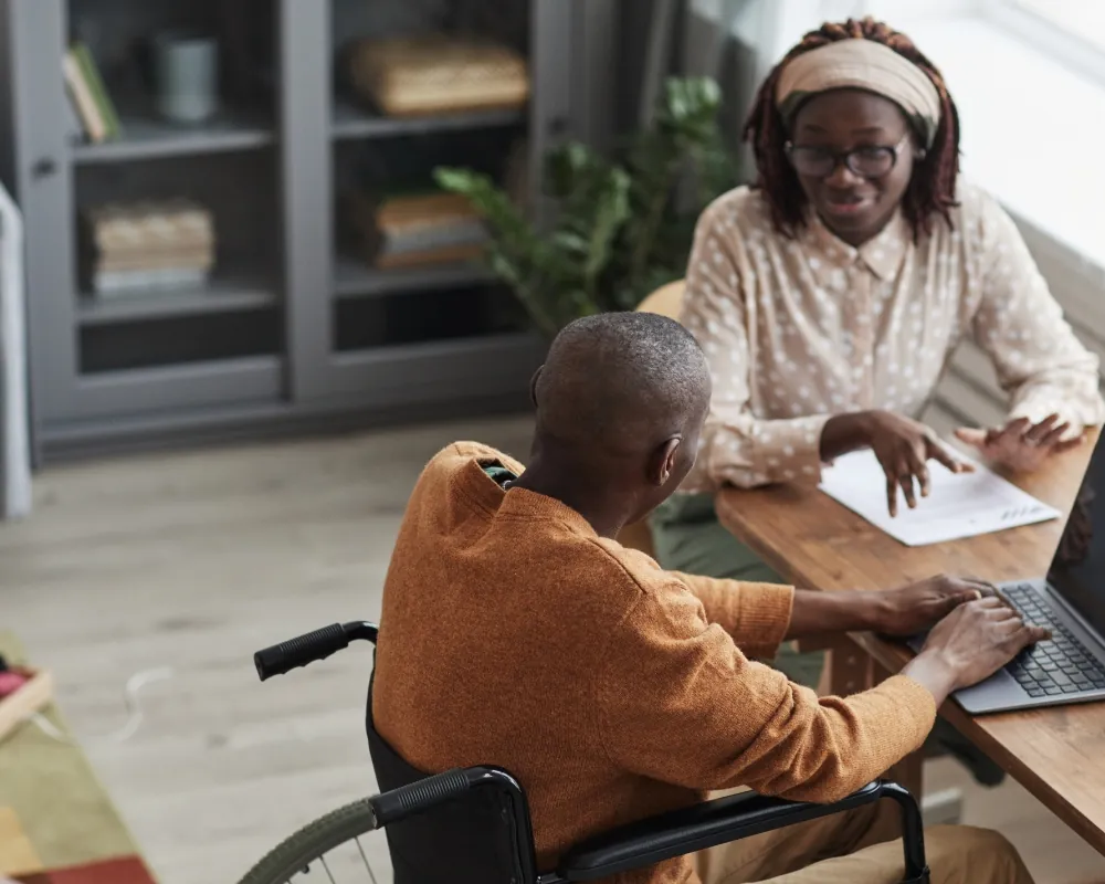 Care coordinator helping senior man with paperwork