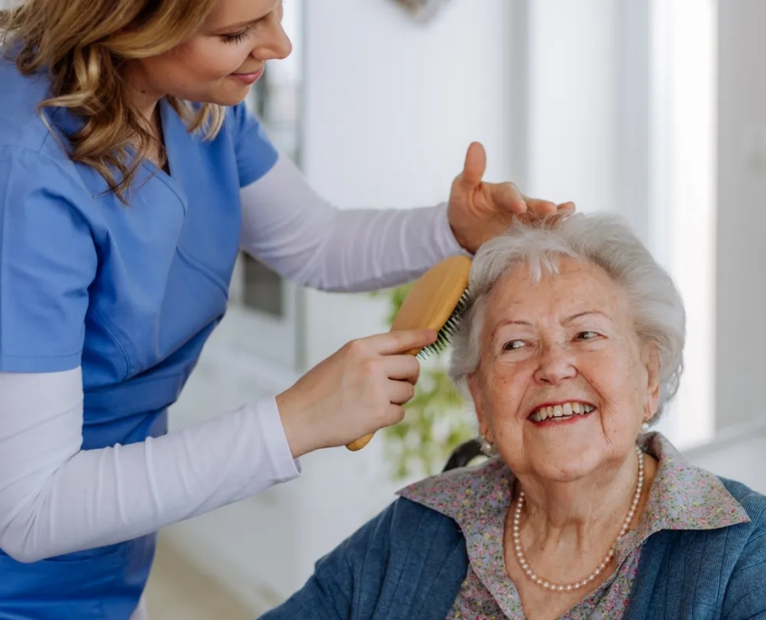 caregiver-brushing-senior-womans-hair-bethesda-md Caregiver brushing senior woman's hair
