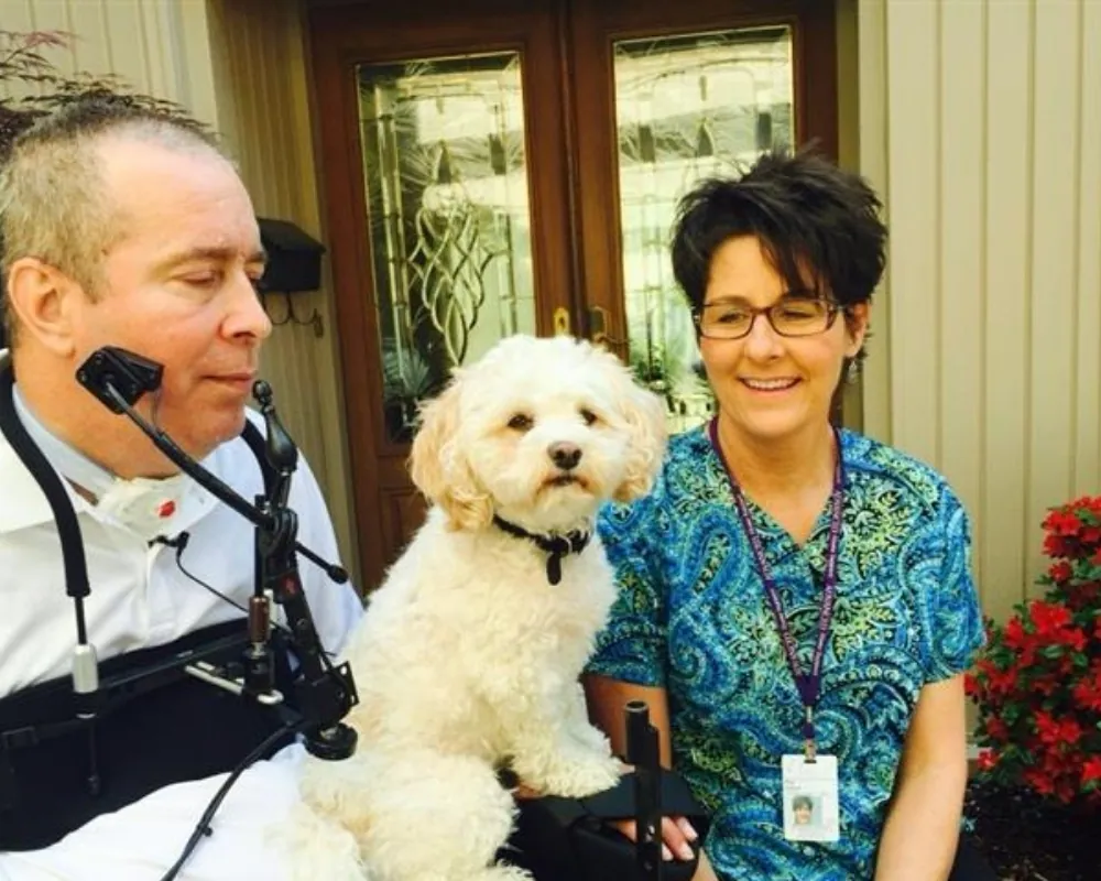 Home health nurse with client in power wheelchair