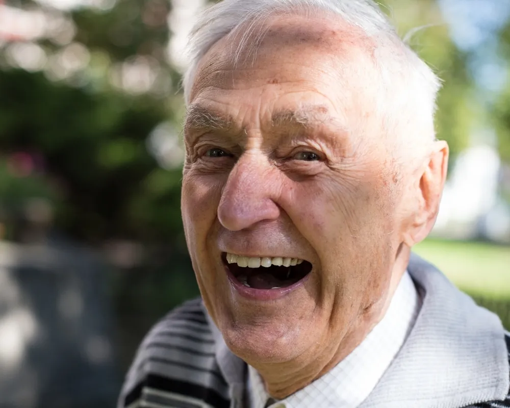 Joyful senior man laughing outdoors
