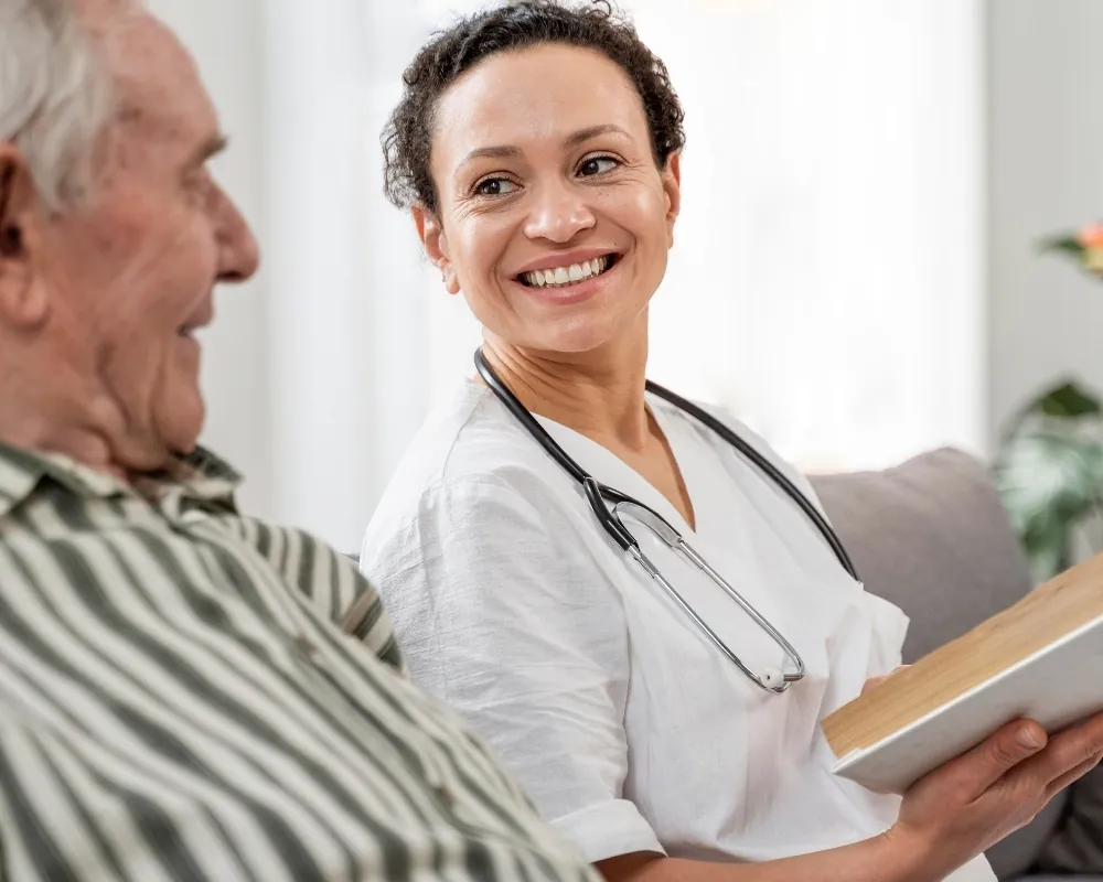 Nurse reading with senior man on couch