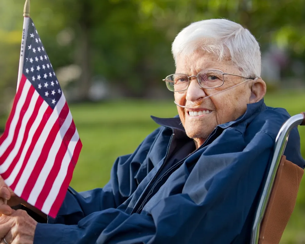 Senior veteran with American flag in wheelchair