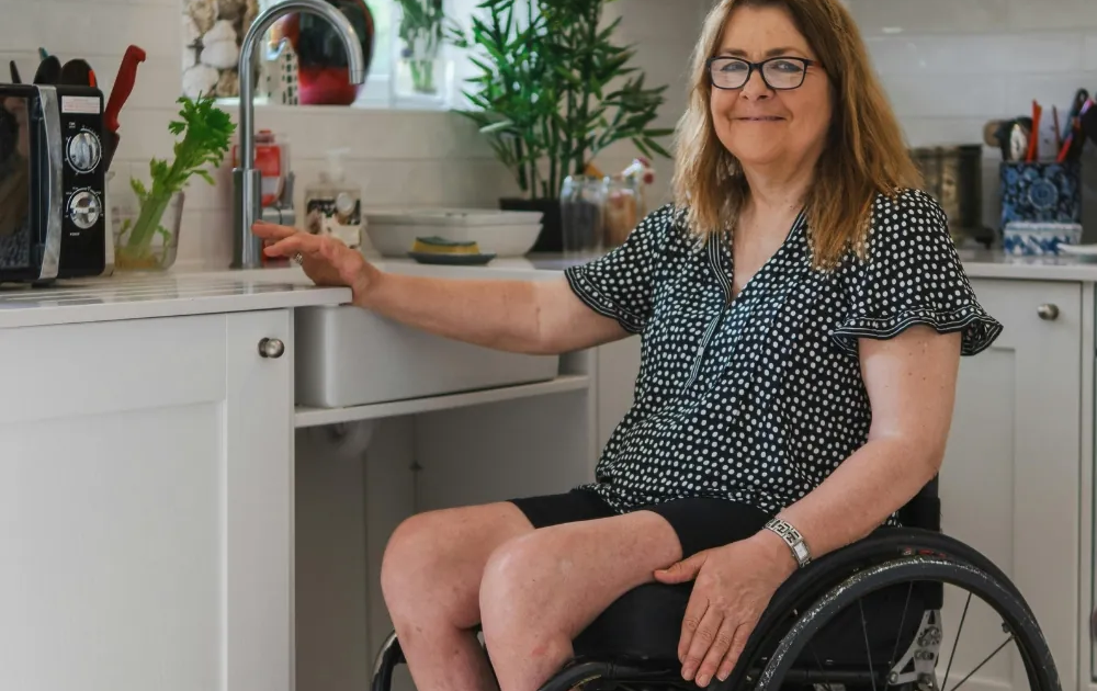 Woman using wheelchair in accessible kitchen