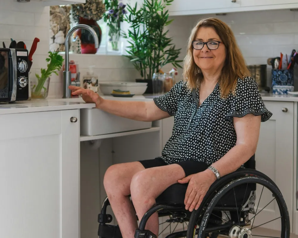 Woman using wheelchair in accessible kitchen