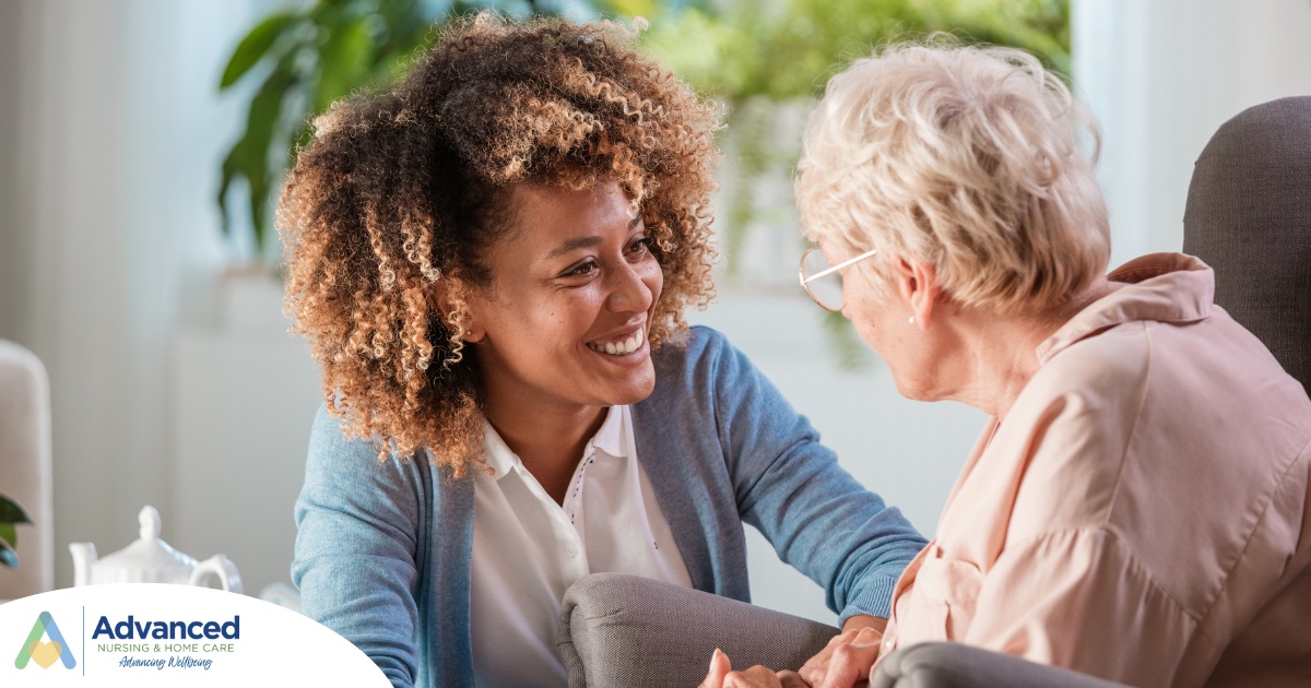 A caregiver warmly speaks with an older client, representing the quality communication that can come with bilingual care.